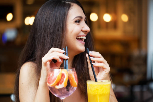 istock Beautiful young woman drinking cold drinks 1341338064