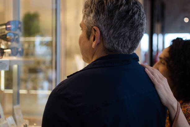 istock couple looking at glasses in the window 1341344590