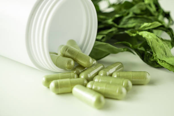 istock Herbal medicine capsules with Andrographis paniculata leaf on white background 1341347237