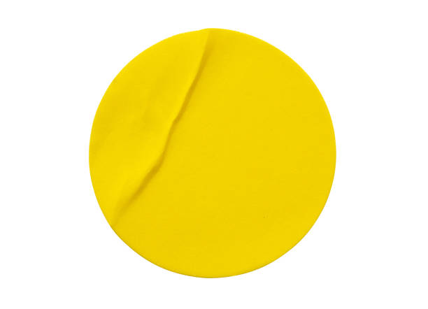 istock Yellow round paper sticker label isolated on white background 1341347256