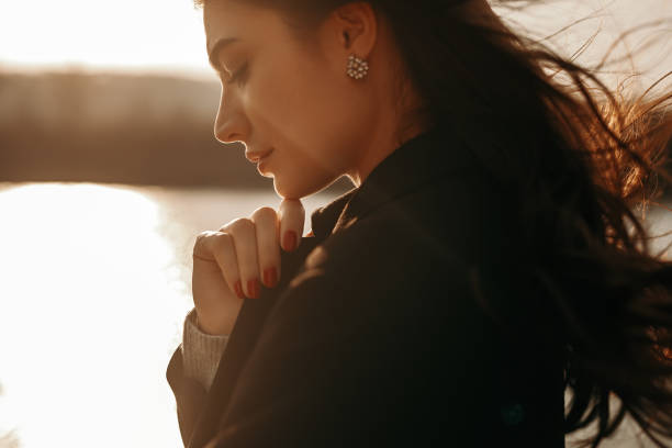 istock Tender thoughtful woman standing on lakeside 1341347298