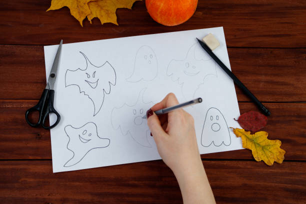 istock Halloween DIY. Step by step instructions on how to draw funny ghosts. 1341351331