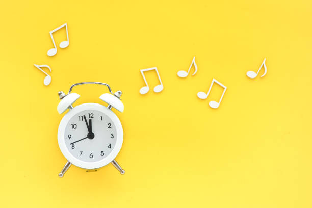 istock white alarm clock on a yellow background and notes around. copy space. concept. 1341360519