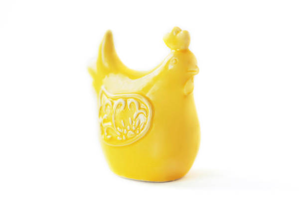 yellow ceramic figurine of a chicken. isolate on a white background.