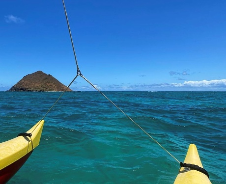Floating in an outrigger canoe off the coast of Oahu, Hawaii.
