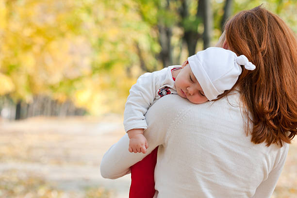 istock Sleeping little girl on mother's shoulder 134136283