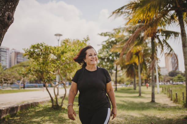 istock old woman walking outdoors 1341363872