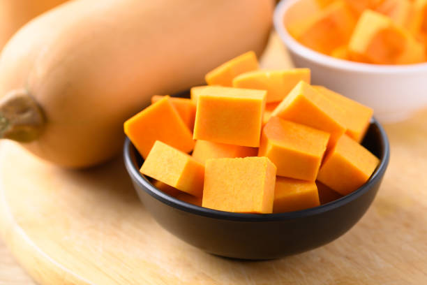 istock Sliced butternut squash in a bowl on wooden cutting board 1341363906