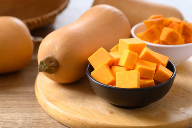 istock Sliced butternut squash in a bowl on wooden cutting board 1341363993