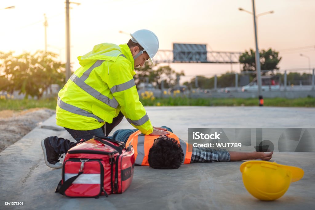 Accident at work of construction labor people, Basic First aid and CPR Training at outdoor. Heat Stroke or Heat exhaustion in body concept. CPR Stock Photo
