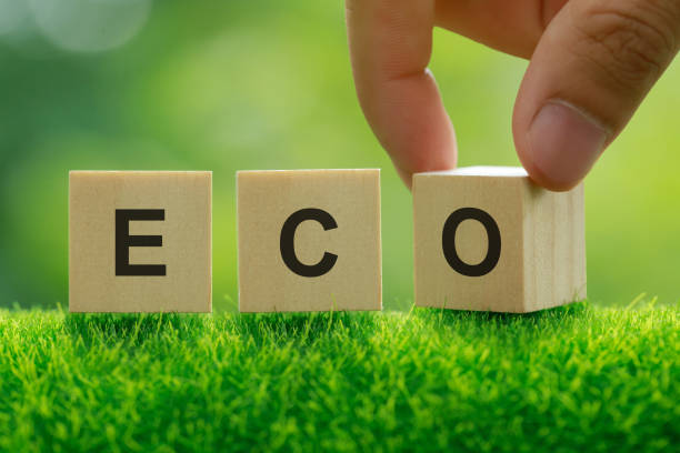 istock Words ECO on a woodblock on green sunny background. Saving environment, save clean planet, ecology concept.eco-friendly agricultural products. Reducing human intervention in ecosystems. quality control. 1341372351