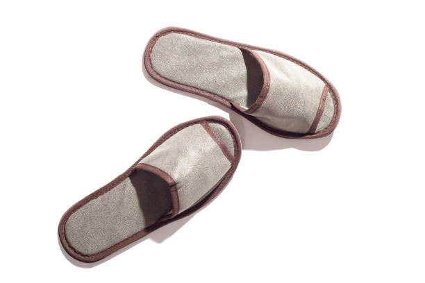 istock Gray one-off slippers for hotel on a white background 1341372413