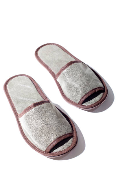 istock Gray one-off slippers for hotel on a white background 1341372415
