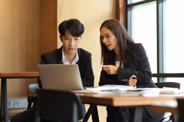 istock Professional businessperson discussing work looking at laptop screen 1341373548