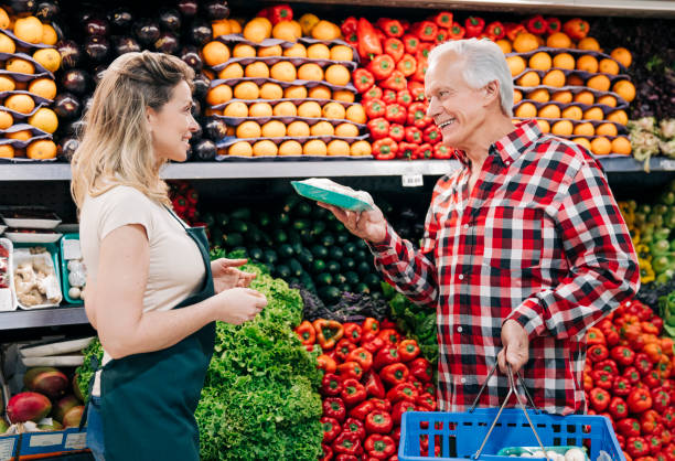istock Owner talking to elderly customer at supermarket 1341375277