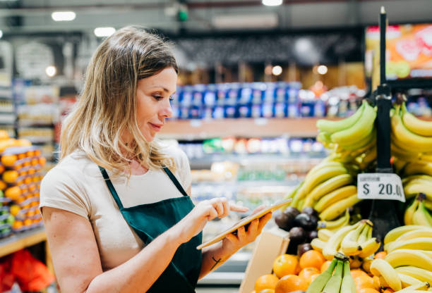 istock Female owner working in supermarket 1341375853