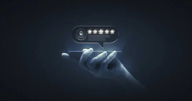 Photo of Hand holding review rating gold star sign or best excellent satisfaction five rate quality ranking success symbol on vote service rank background with like button and positive customer experience.