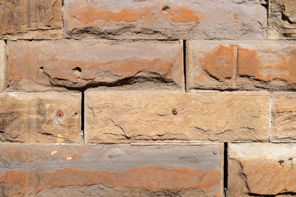 Old weathered sandstone brick wall.