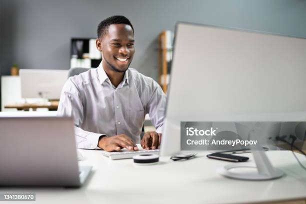 Happy Professional Man Employee Using Computer Stock Photo - Download Image Now - Desktop PC, African Ethnicity, Men