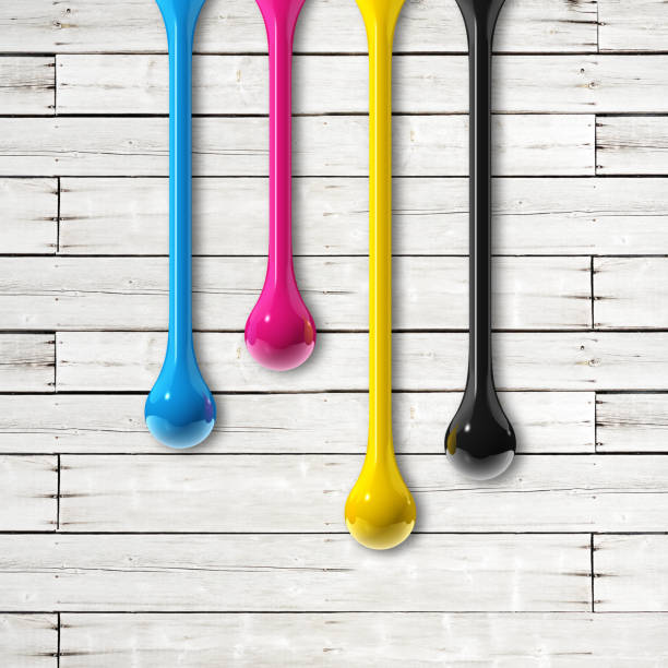 istock cmyk ink drops on white wooden square background 1341380855