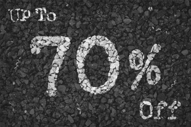 istock Black and white coloured pebbles making a rustic poster with text Up to 70 % Off painted on gravel road with small swirls pattern, for  clearance up to seventy percent SALE related vector backgrounds 1341380872