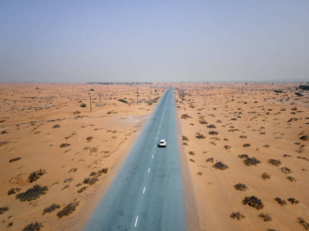 scenic desert road in the united arab emirates aerial drone top view - vista aérea de carro isolado imagens e fotografias de stock