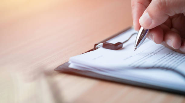 istock Close-up of Hand using writing pen with questionnaire 1341384364