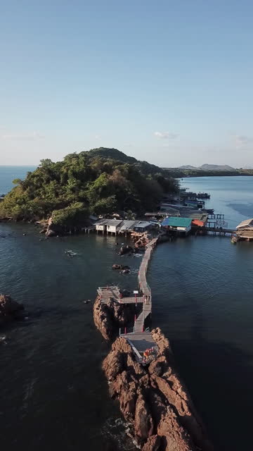 Young couple drone selfie at Beautiful Chanthaburi buddha temple over water