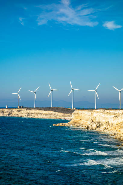 istock Rocky seashore and Wind turbines 1341384998