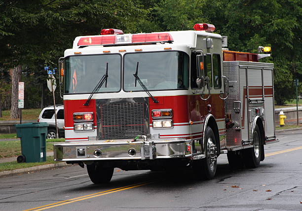 Fire Truck rushing to the rescue Fire Truck rushes to the scene of house fire emergency response workplace stock pictures, royalty-free photos & images