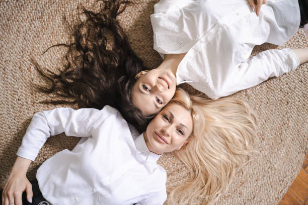 istock Mom and daughter lying on floor 1341391215