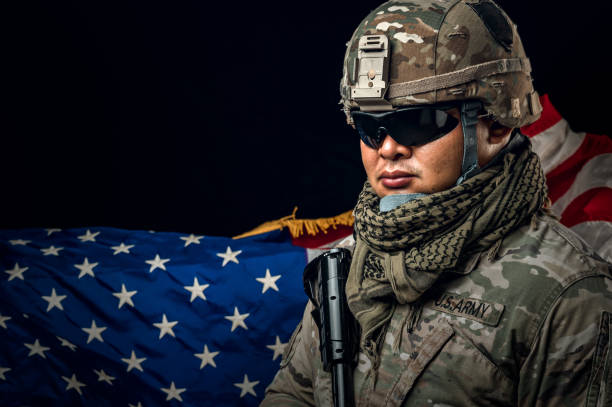 Photo of soldier holding the USA flag in background. Special force United States soldier or military contractors holding rifle. Image on background. soldier, army, war, weapon and technology concept. foto de un soldado sosteniendo la bandera de los estados unidos en el fondo. soldado de la fuerza especial de los estados unidos o contratistas militares que sostienen un rifle. imagen sobre fondo. concepto de soldado, ejército, guerra, arma y tecnología