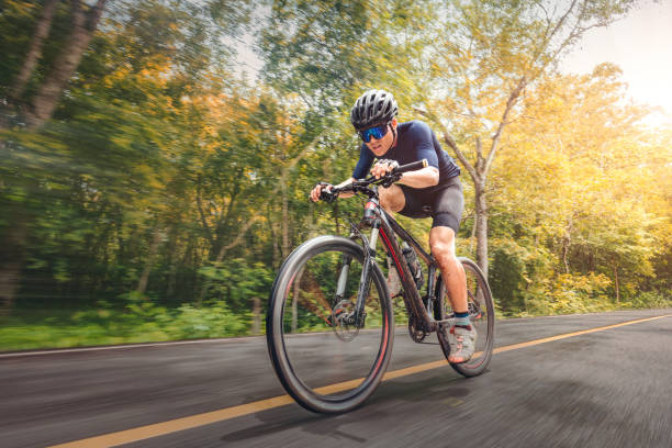 cycling mountain bike cycling mtb on the road shady with forest. mountain biking athlete look at wild nature on mountain. extreme sport and mtb, mountain bike downhill of motion concept. - journey footpath exercising effort imagens e fotografias de stock