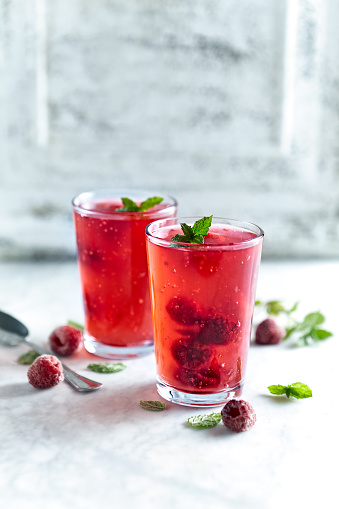 Raspberry kissel with whole fruits and mint leaves