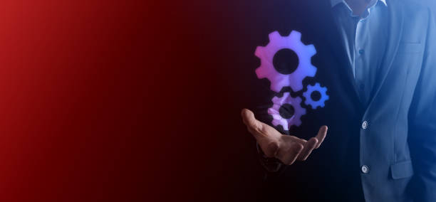 istock An empty workpiece. A businessman in a suit on a black background holds his hands protective gesture. A gesture of care and patronage. 1341394453