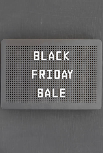istock 'Black Friday Sale' words on a black lightbox on a black surface, top view. From above, overhead, flat lay. 1341394475