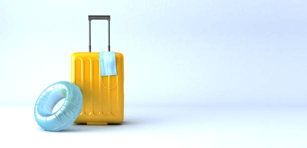 istock yellow suitcase with face mask and travel accessories on light blue background. 3d rendering 1341394674