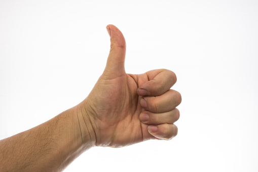 Thumbs up on white background.