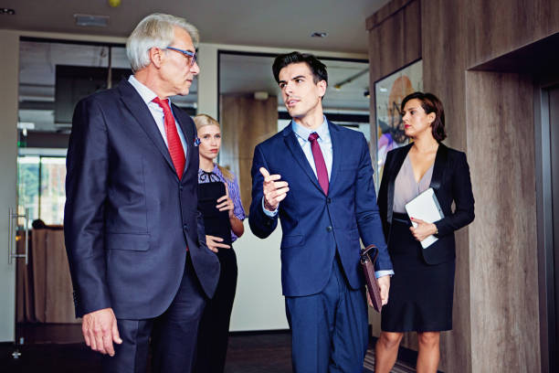istock Coworkers are waiting for elevator in a company building 1341395551