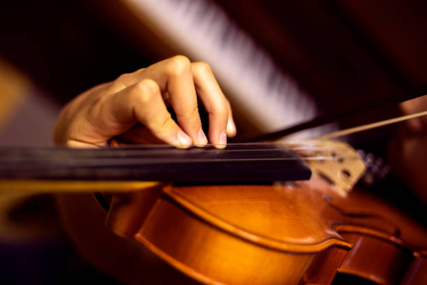 istock left hand of a young violinist presses the strings on the violin neck, horizontal 1341397746