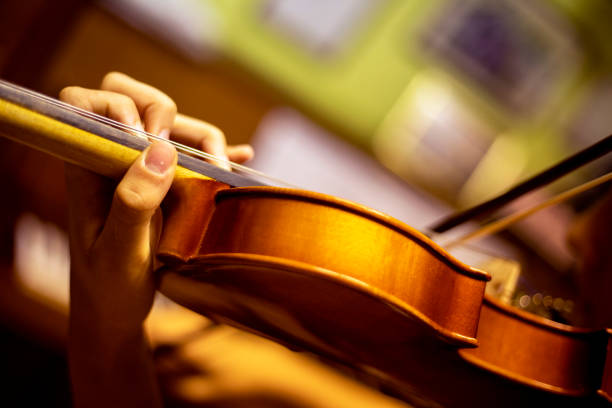 istock left hand of a young violinist presses the strings on the violin neck, horizontal 1341397758