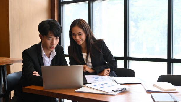 istock Business people discussing business data together on computer laptop. 1341398743