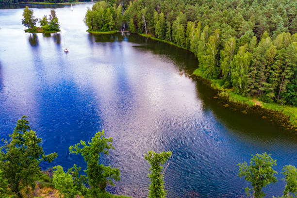 Aerial view yacht on lake in Tuchola Forests, Poland. Aerial view of boat yacht on lake during summer. Tuchola national park in Poland. Yachting, holidays concept. bory tucholskie stock pictures, royalty-free photos & images
