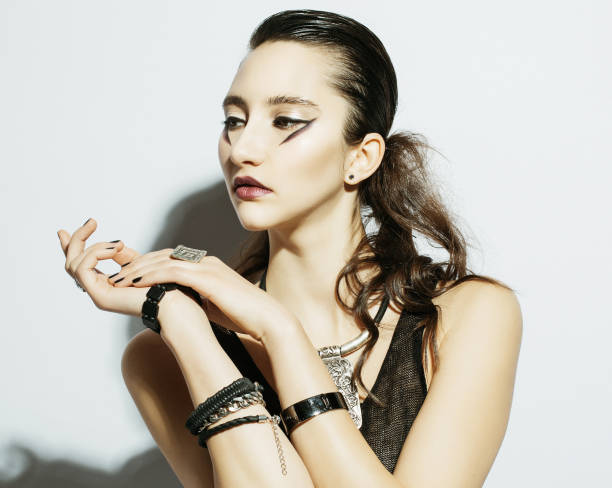 istock Fashion model with luxury make up wearing black outfit posing 1341402151