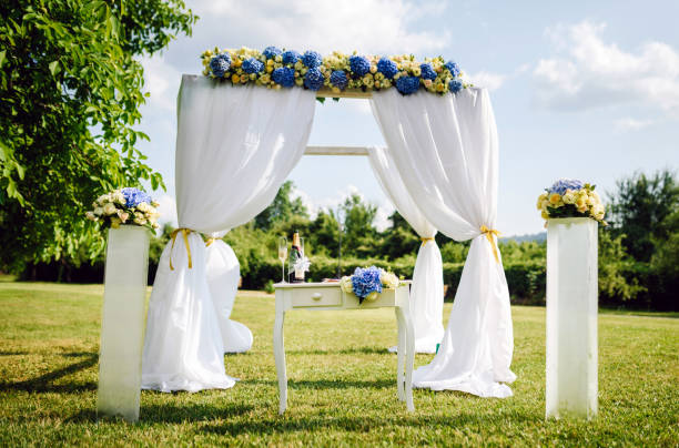 white gust chairs in a row of a outdoor wedding in the garden.