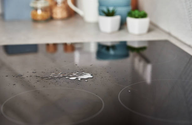 istock Cleaning spray on induction stove. Clear kitchen appliance 1341406705