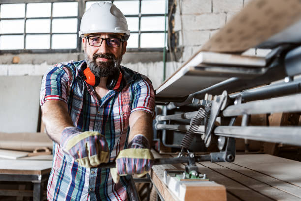 istock Mature Manual worker working with wood in carpentry. 1341406865