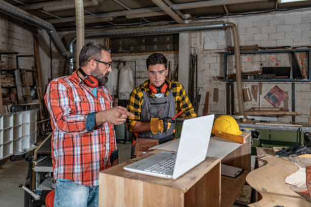 istock Father and son working in carpenter shop 1341406900
