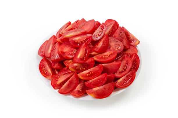 istock Pieces of red tomatoes on dish on a white background 1341407152