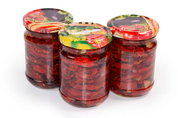 istock Dried tomatoes in oil in closed jars on white background 1341407228